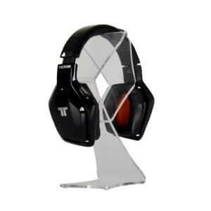 A clear acrylic countertop headphone stand with headphones on display.