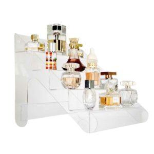 A clear acrylic countertop display with multiple tiered shelves holding different perfumes.