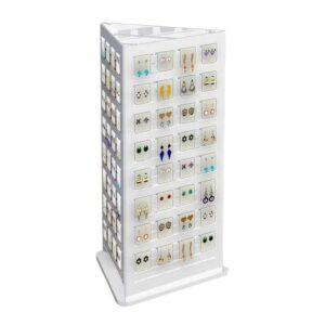A rotating countertop jewellery display holding different earrings.