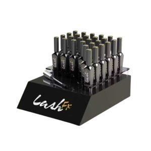 A countertop display holding mascara bottles.