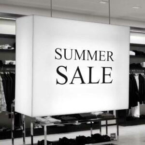 A ceiling mounted lightbox with "summer sale" written on.