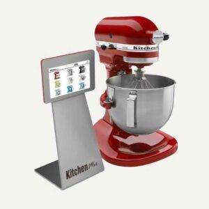 A blender with a digital screen on a stand next to it.