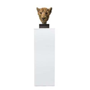A white flat pack plinth with a sculpture on top.