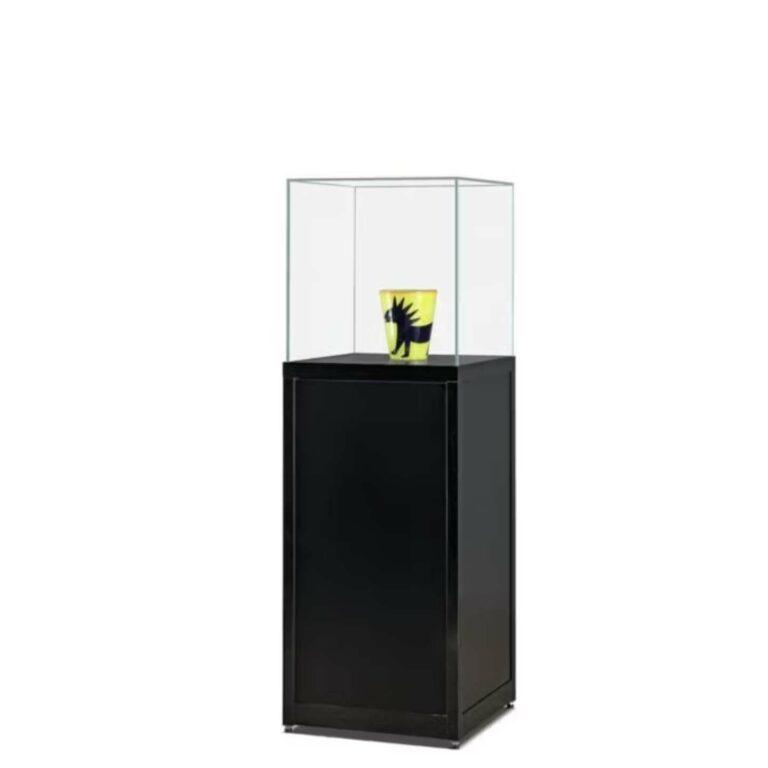 A lockable plinth with a vase inside.