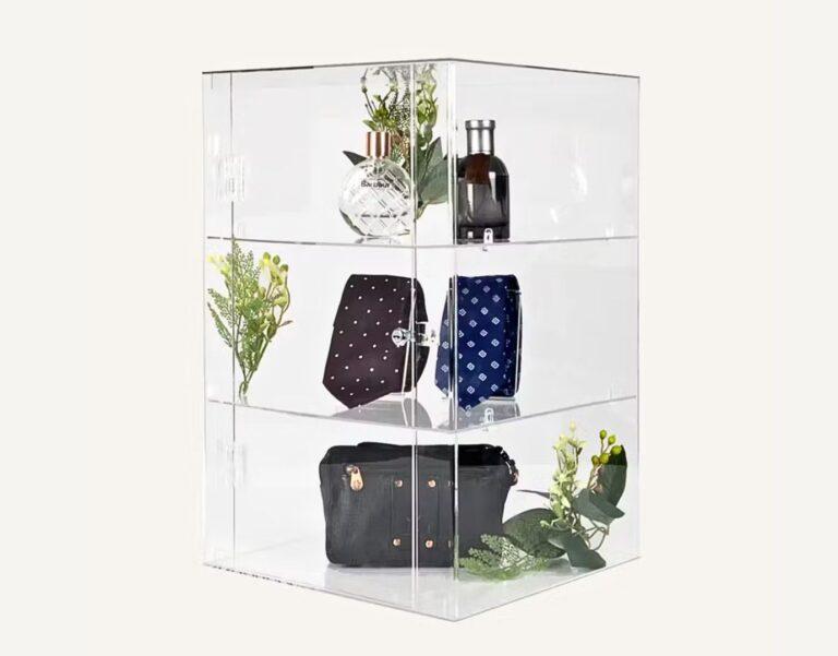 A clear acrylic lockable cabinet with products inside.