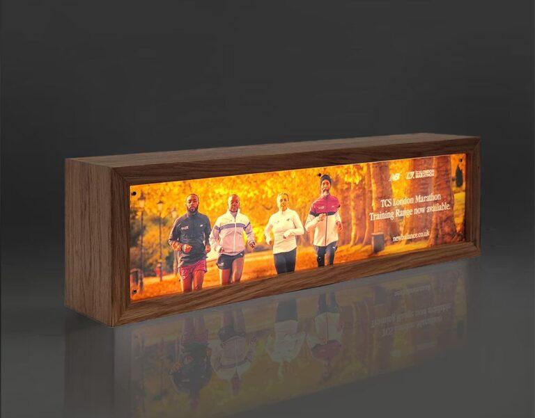An illuminated lightbox display made from wood.