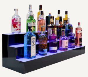 An illuminated, tiered, colour changing drinks shelf.
