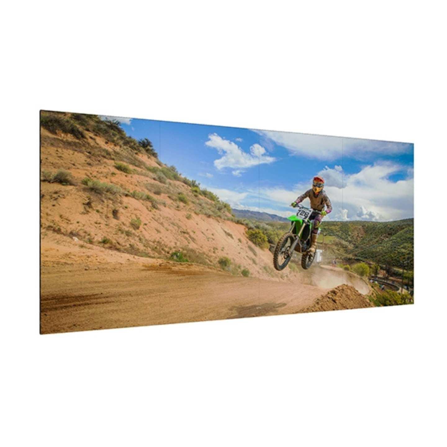 An ultra narrow bezel LCD video wall display with an off rode biker on the screen.