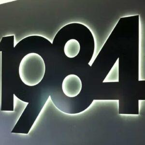 Illuminated numbers on a wall.