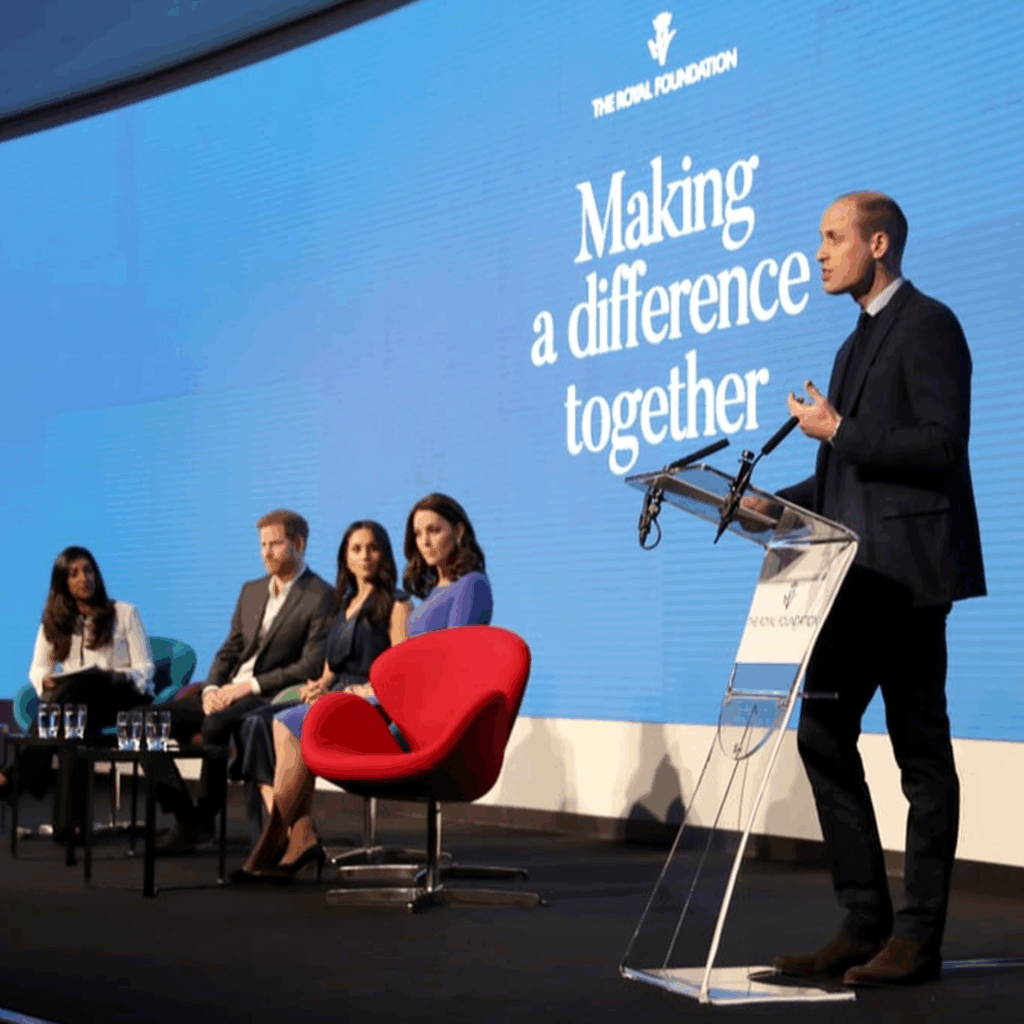 Prince William speaking at a conference with other royal family members, stood in front of a Luminati clear acrylic lectern.