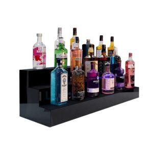 A black three tiered back bar display plinth with different alcoholic spirits sat on top.