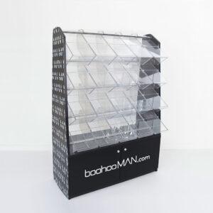 Custom black pick and mix display stand featuring branded side panels and front logo, with multiple clear acrylic compartments and a lower storage cabinet on a white background.