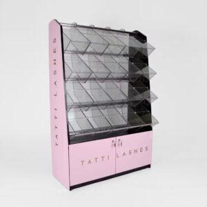 Elegant pink and black pick and mix display stand with clear acrylic compartments and a branded lower cabinet featuring gold “Tatti Lashes” lettering, set against a plain white background.