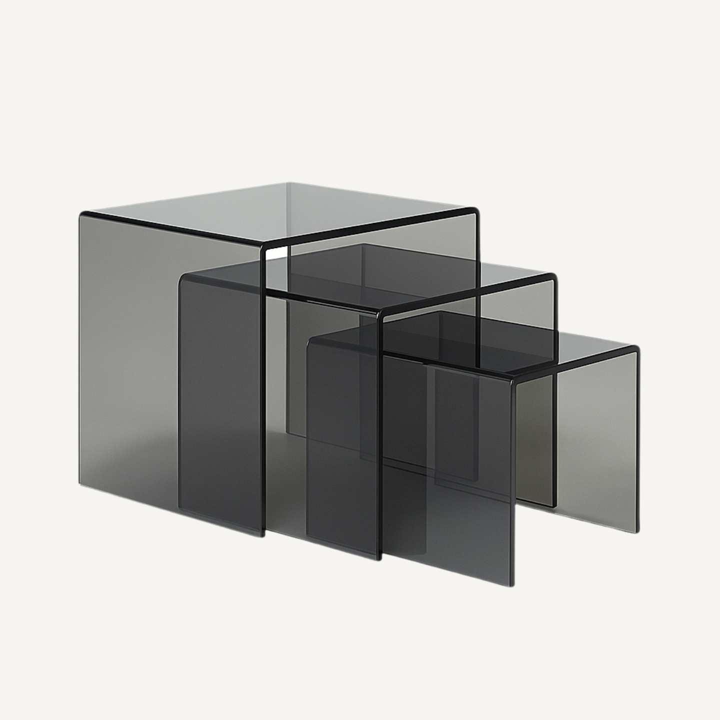 A set of three acrylic smoked tinted grey coloured acrylic nesting tables.