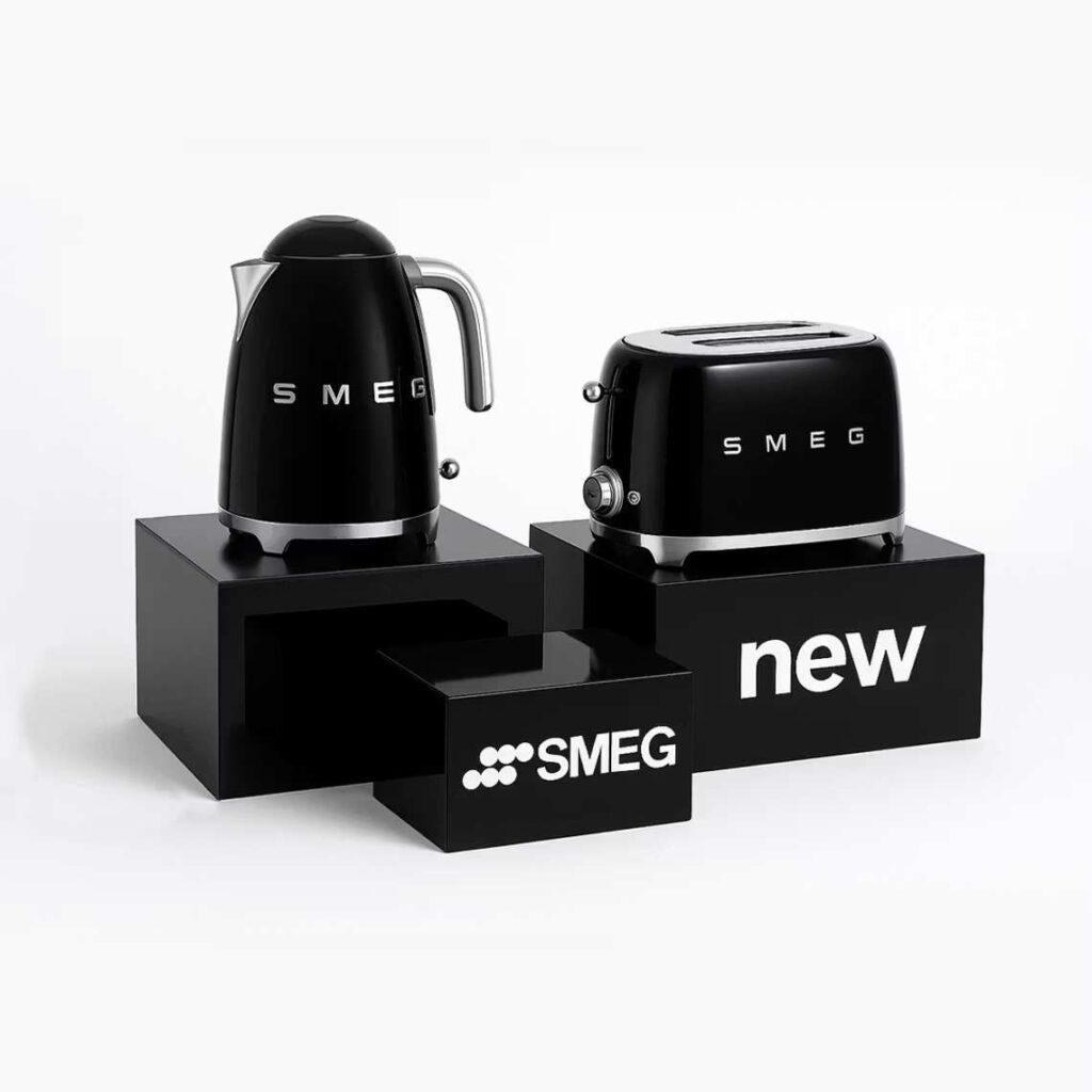 A set of three glossy black countertop plinths with a kettle and toaster on display.