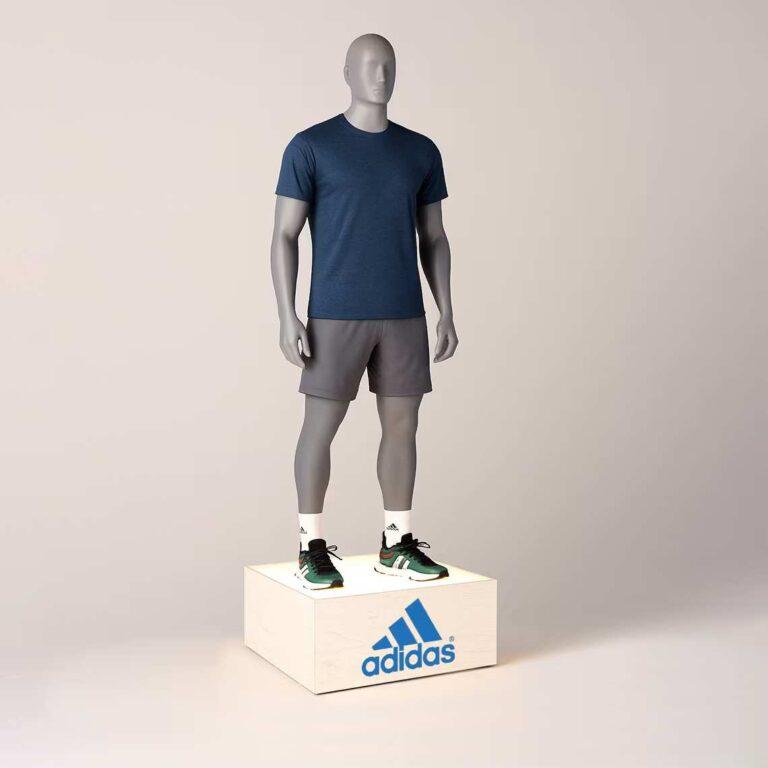 A wooden retail podium with illuminated top and custom branding, featuring an adidas logo and a mannequin stood on top, perfect for retail.
