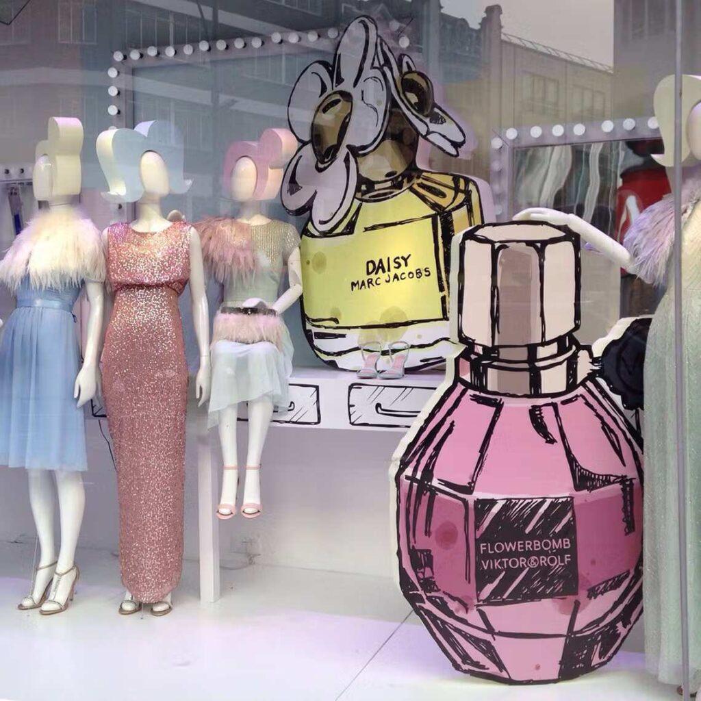 A shop window display for Marc Jacobs's daily perfume, with mannequins and printed polystyrene cut outs.