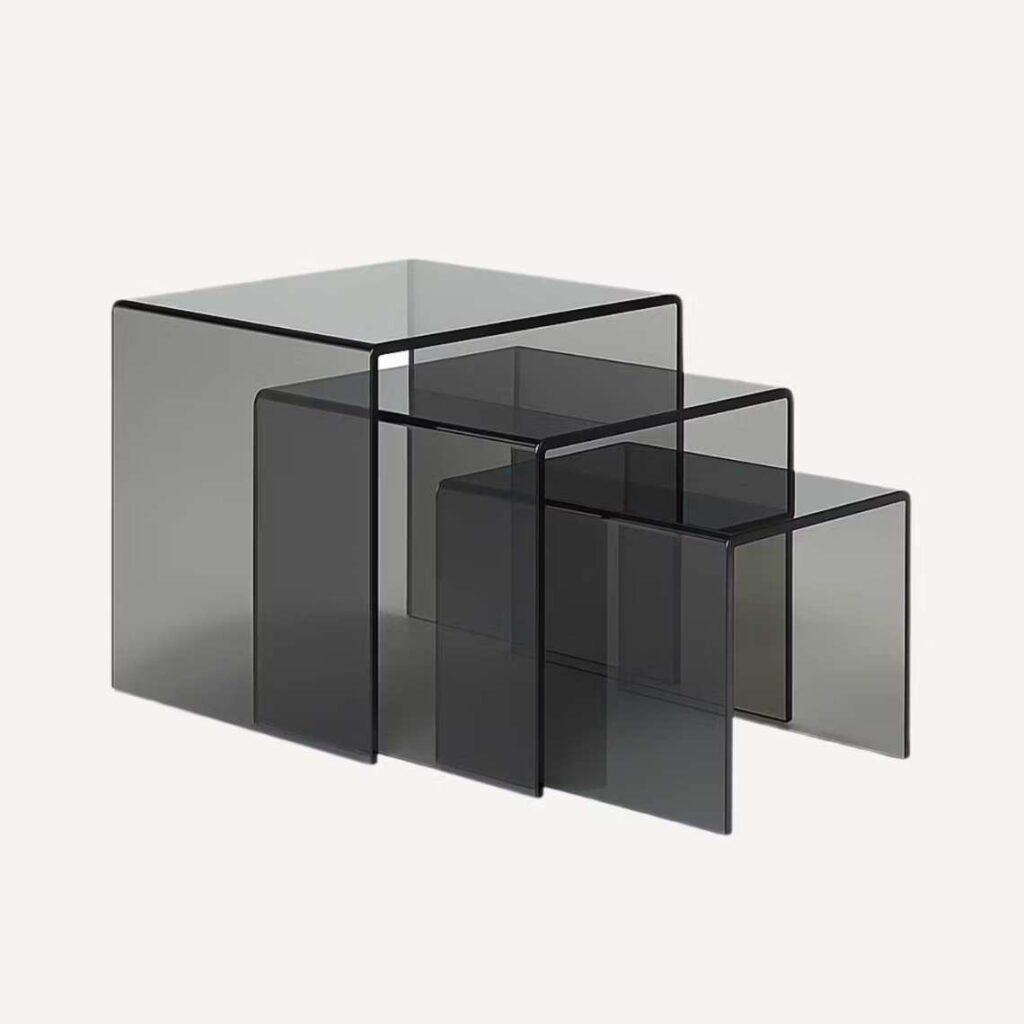 A set of three smoked grey nest of tables.