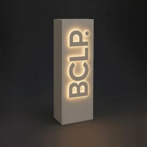 A white illuminated logo plinth with a custom BCLP 3D logo on the front.