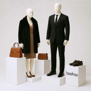 Different sized satin white MDF branded and non branded retail display podiums with accessories and a male and female mannequin on display.