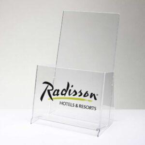 A clear acrylic brochure dispenser with a custom Radisson logo on the front panel.