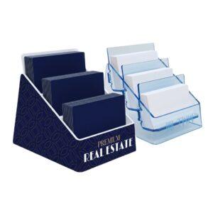 Two bespoke tiered business card dispensers, one with custom branded graphics and one in transparent blue acrylic and laser engraved logo, each featuring multiple stepped compartments for displaying business cards.