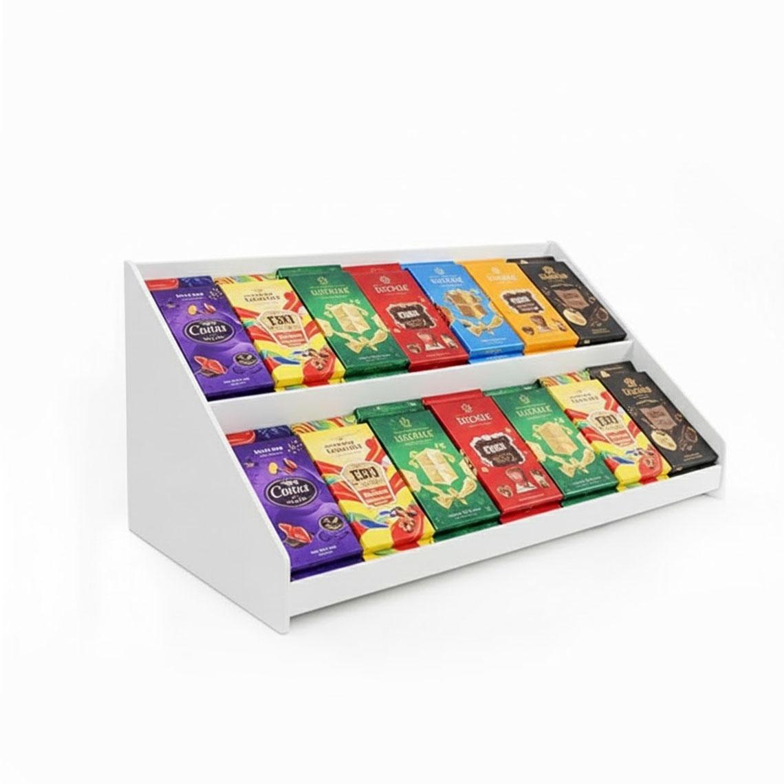 White right-facing countertop point-of-purchase display holding chocolate bars.