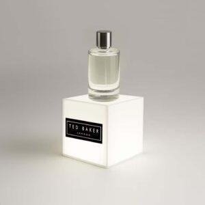 A Ted Baker custom made illuminated plinth lightbox with a perfume placed on top.