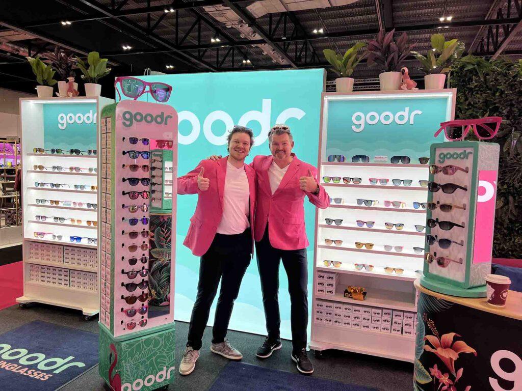 Custom LED illuminated retail display units designed and manufactured for Goodr sunglasses featuring backlit branding panels and eyewear merchandising at a trade show stand.