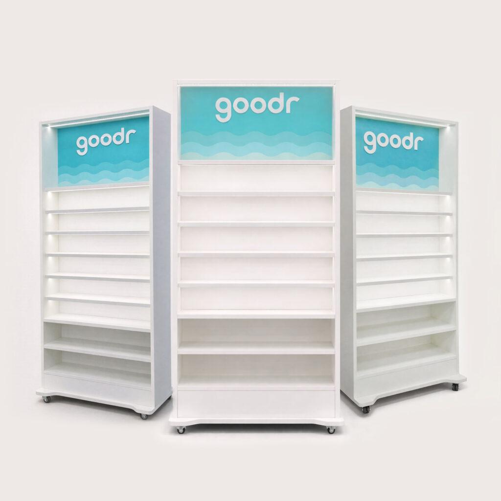 Modular illuminated retail shelving units with LED backlit branding panels and display shelves on caster wheels