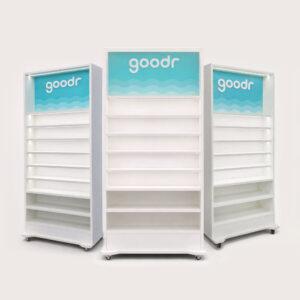 Modular illuminated retail shelving units with LED backlit branding panels and display shelves on caster wheels