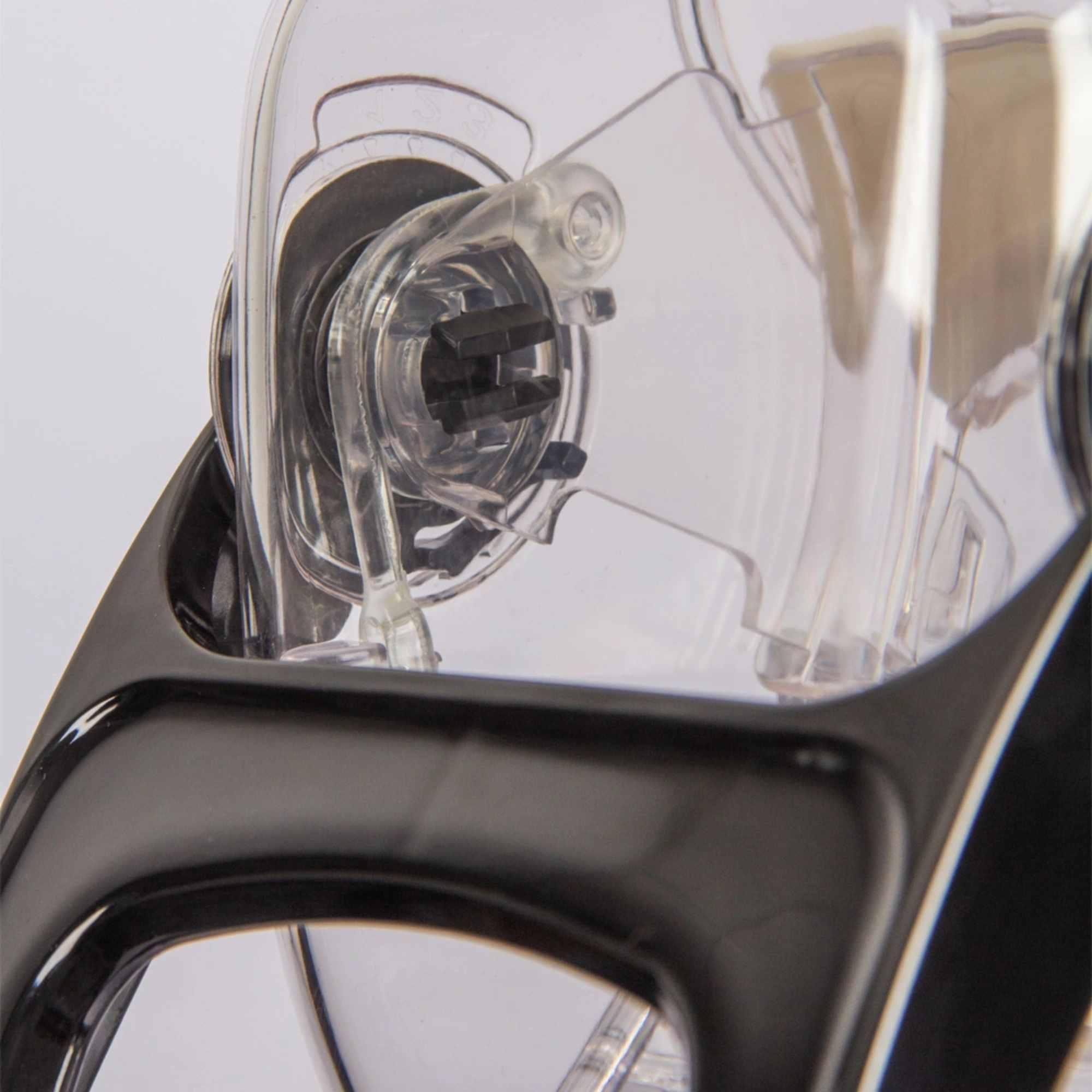 Close-up of gravity feed mechanism on clear acrylic bulk food dispenser unit.