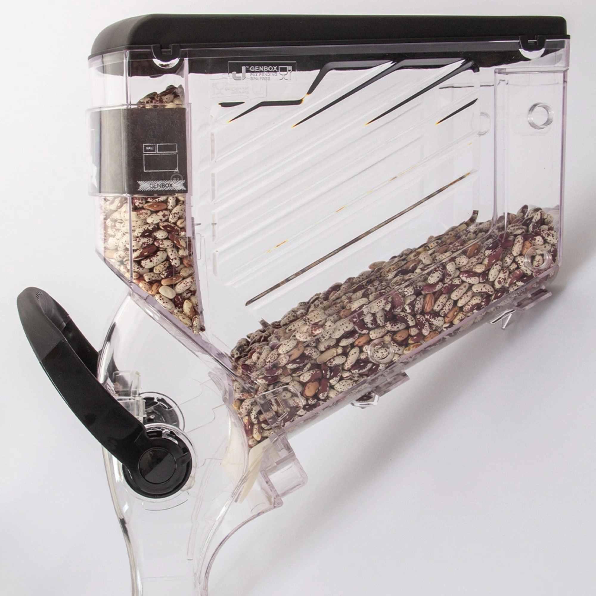 Side view of clear acrylic gravity-fed food dispenser showing internal storage and flow system.