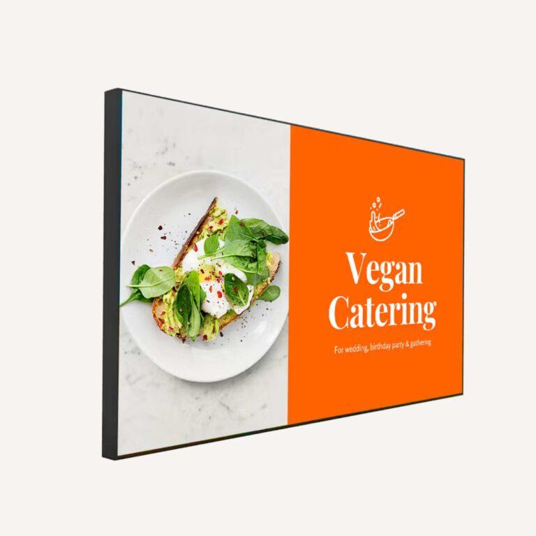 A high-brightness digital screen with a catering promotion on it.