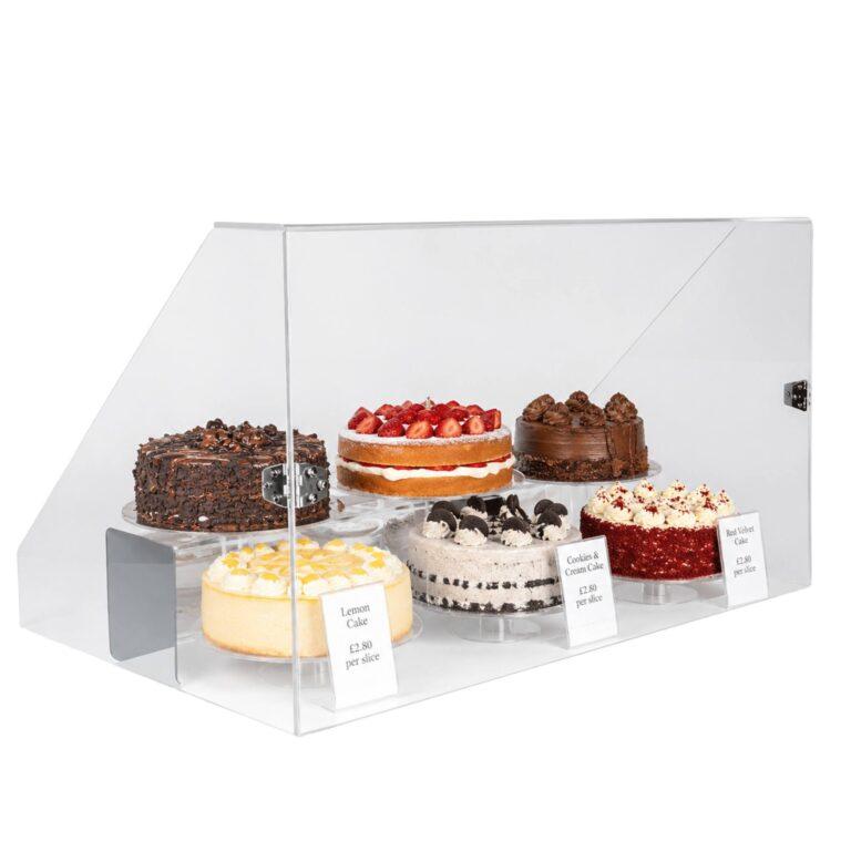 A food guard with cakes on display.