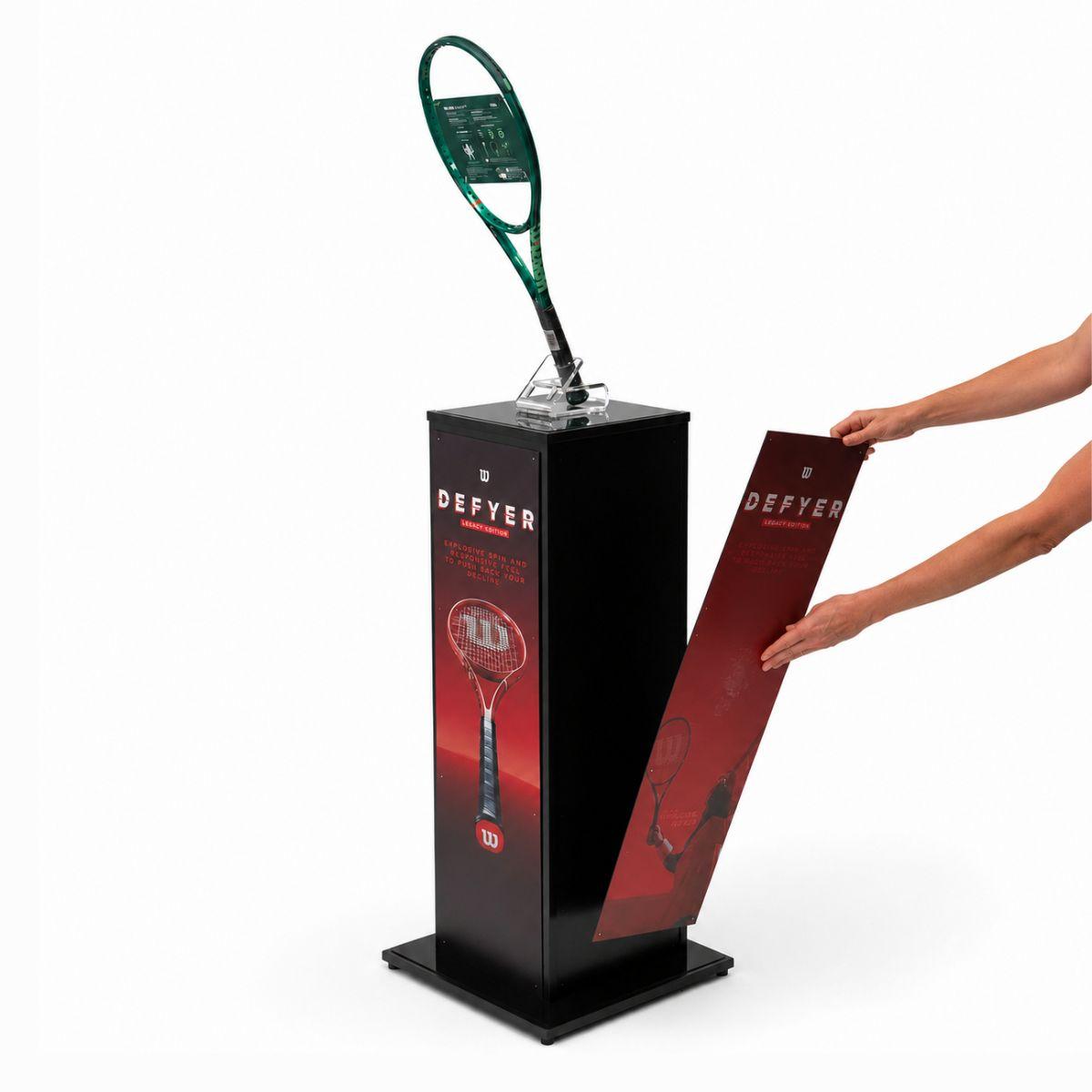 Black branded retail display plinth with removable magnetic graphic panel and product holder