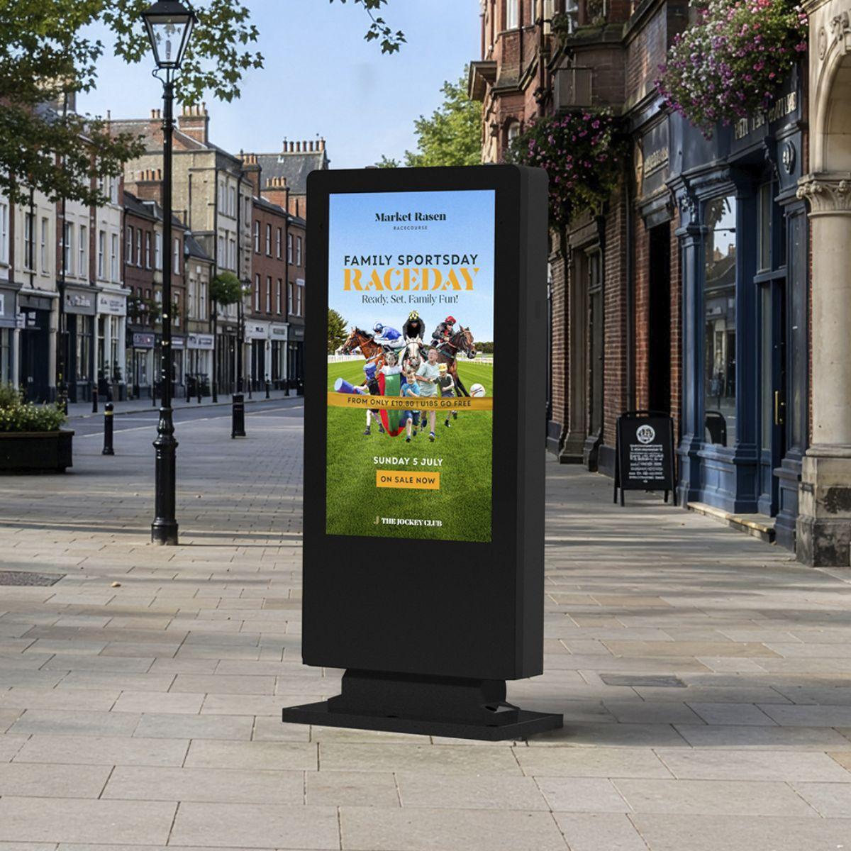 55-inch 4K outdoor freestanding digital advertising screen displaying race day content on a UK high street