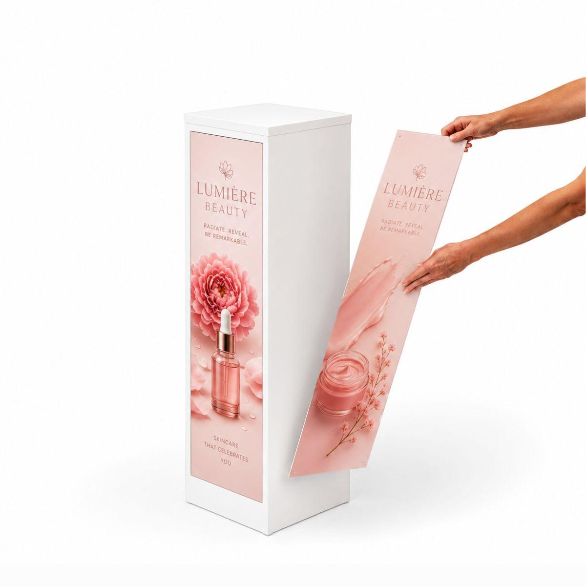 White promotional display plinth with interchangeable magnetic graphics for beauty product branding