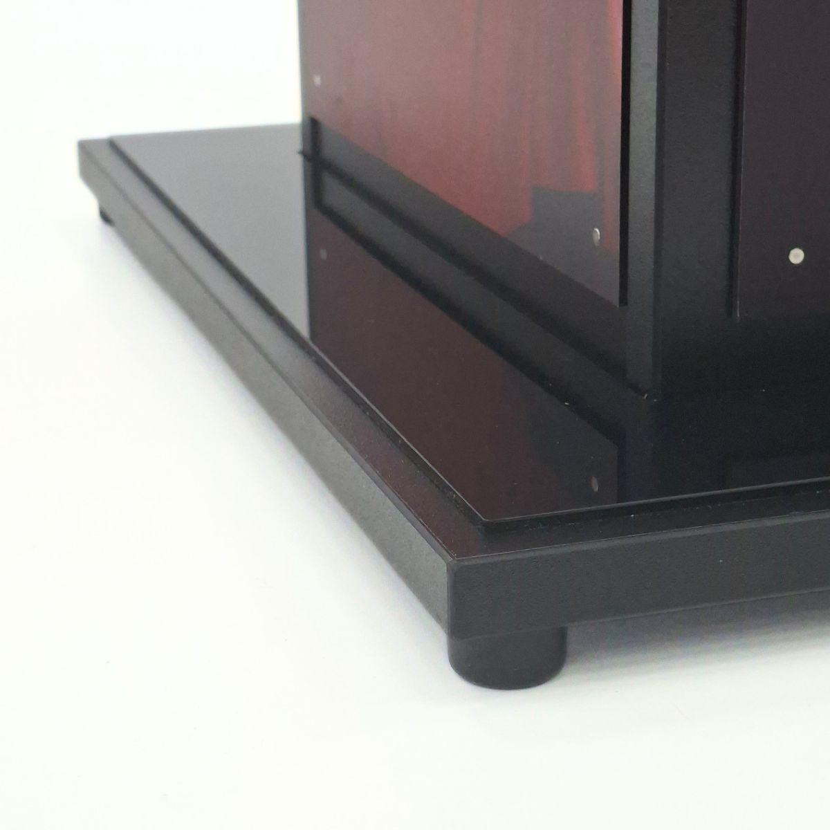Close-up of black display plinth base showing durable construction and retail display finish